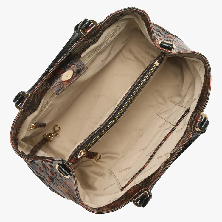 An open brown crocodile-embossed handbag with a beige interior lining, shown from a top-down angle against a white background.