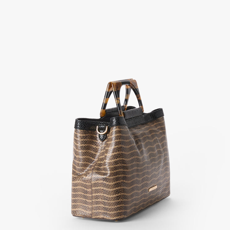 Small Denise handbag with wavy pattern and tortoiseshell handle on a white background. Side view.