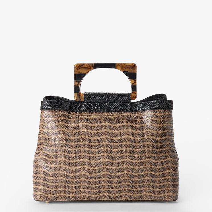 Small Denise handbag with wavy pattern and tortoiseshell handle on a white background. Back view.