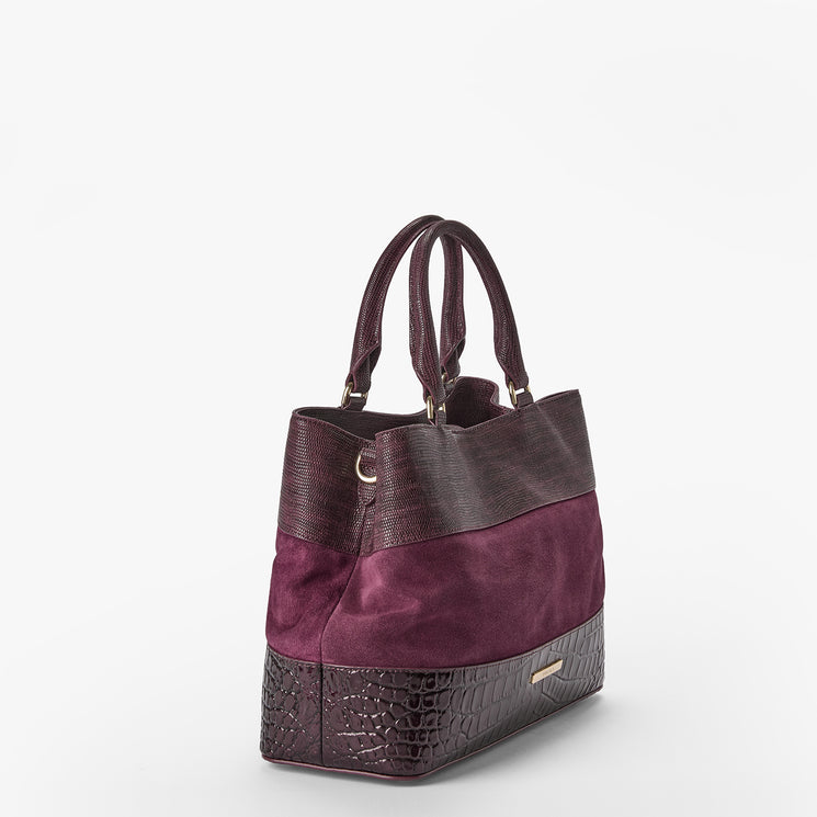 A structured tote bag featuring a color-blocked design with dark brown textured faux-crocodile leather on the top, bottom, and handles, and a deep purple suede panel in the middle. A small gold brand plaque is visible on the lower right front edge.