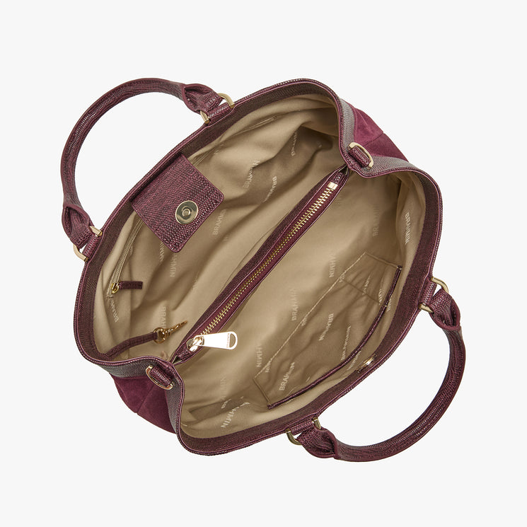 An open burgundy handbag with a beige interior, shown from a top-down view against a light gray background.