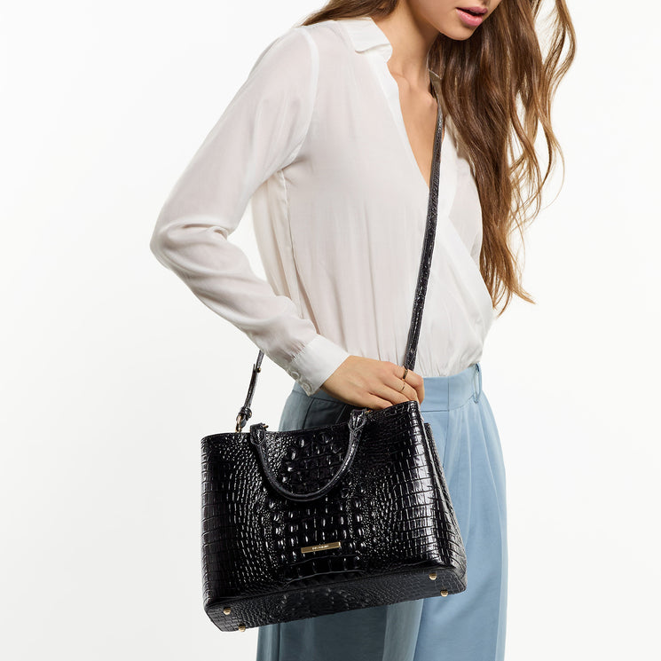 Woman wearing Black Melbourne Small Denise as a crossbody against a white background