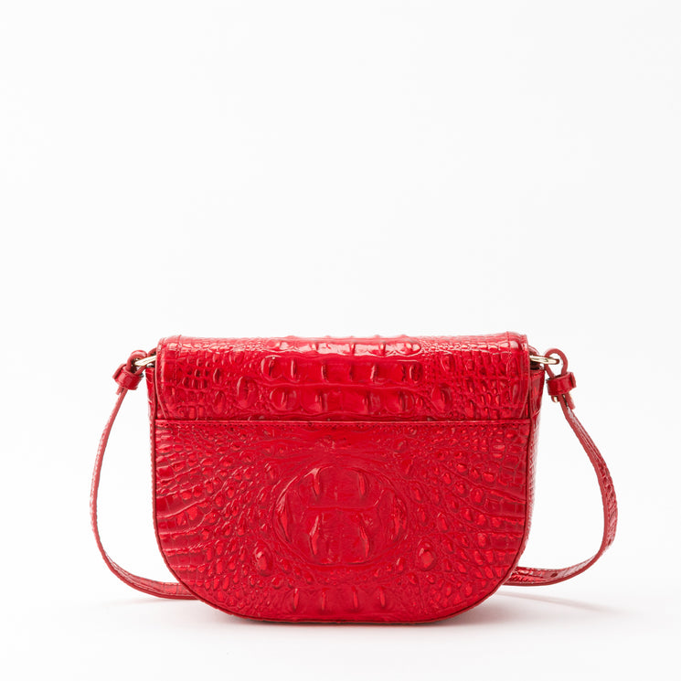 Brahmin Portia crossbody bag in holiday red, featuring a saddle silhouette, flap closure, and a textured, croc-embossed finish.