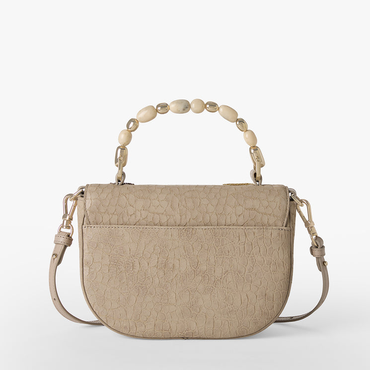 Beige handbag with butterfly and fern designs on a white background. Portia back view.