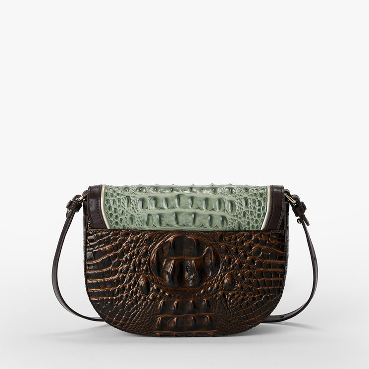 A crocodile-embossed leather shoulder bag with a dark brown body and a contrasting light green textured flap, shown on a light gray background.