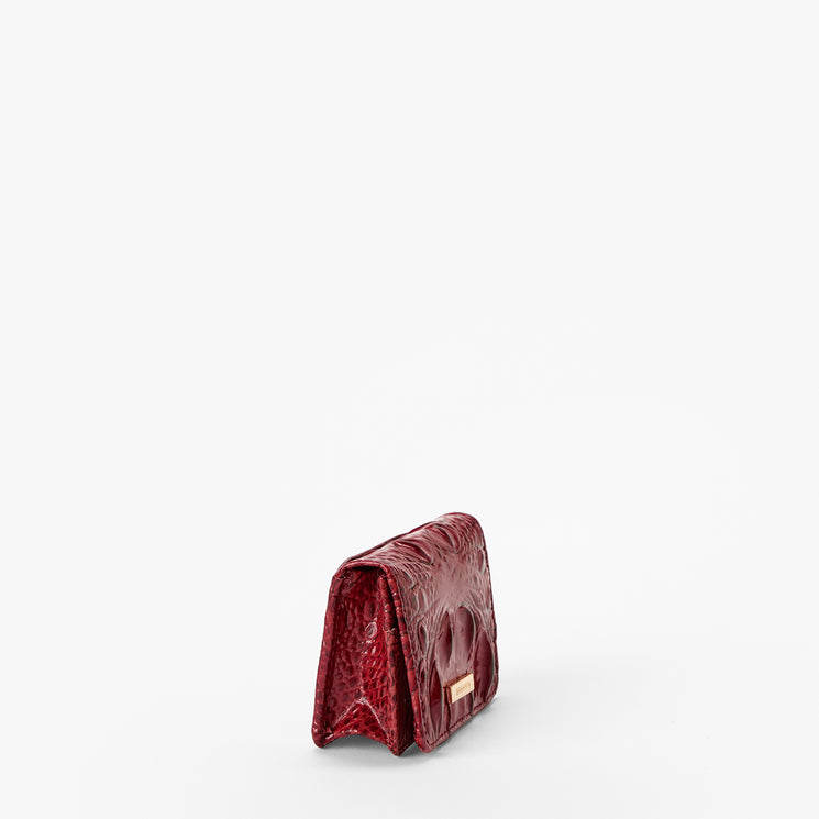 Volcanic Red Melbourne croc textured wallet on a light gray background. Clementine side view.