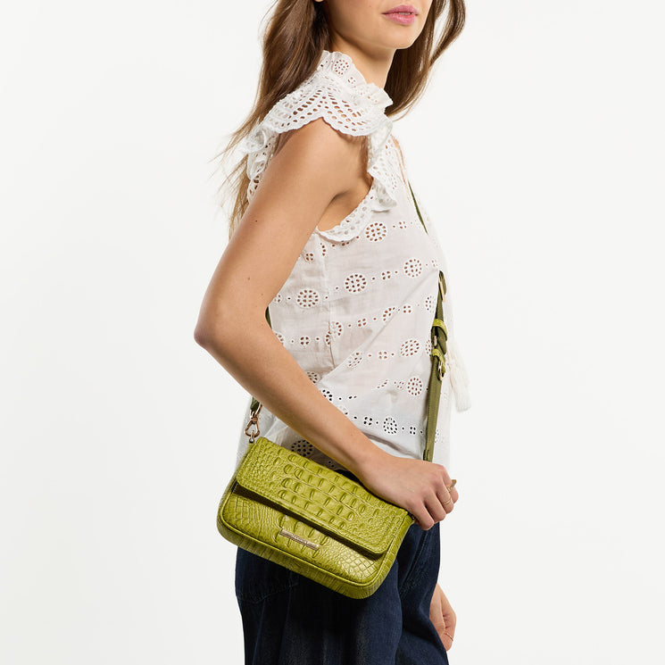 Woman wearing Ayla crossbody bag against a white background