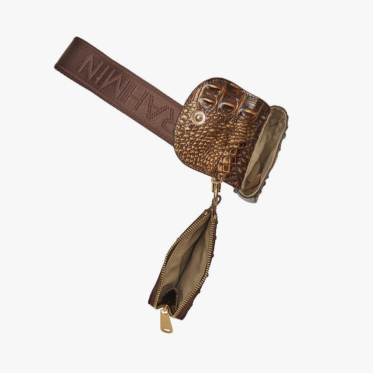 A brown textured leather crossbody bag with a matching zippered pouch hanging from a gold-tone zipper, shown on a plain light gray background. Etta open top view.