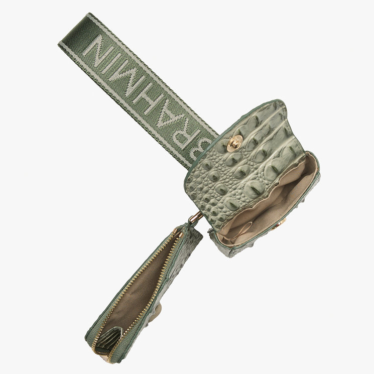 An olive green crocodile-embossed leather pouch with a matching fabric strap featuring the brand name 'BRAHMIN' in white, shown open on a light gray background.