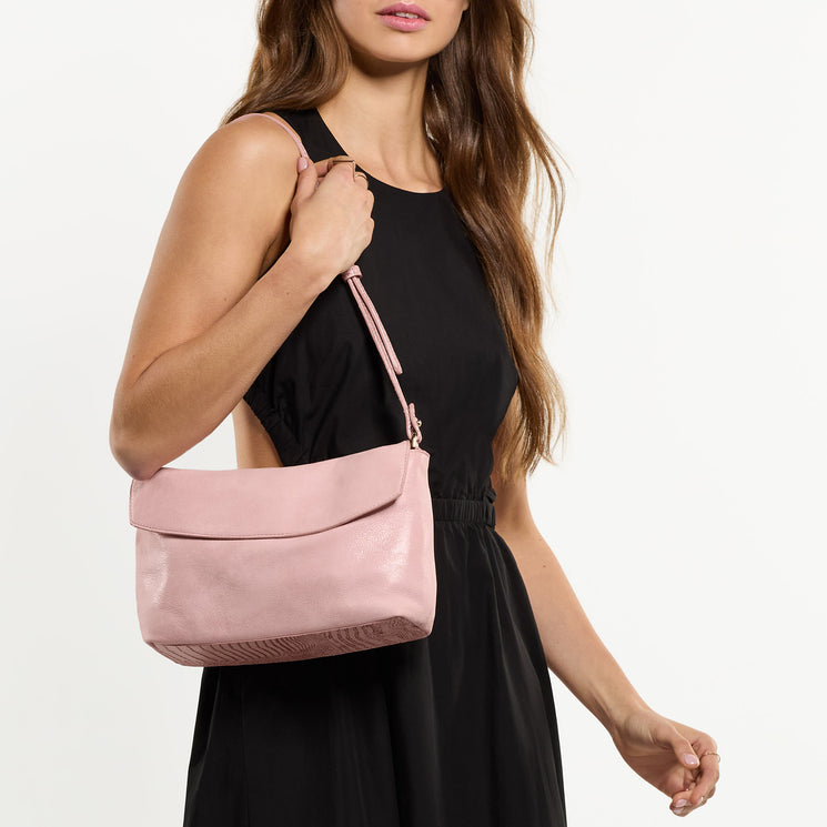 Woman wearing Kalina shoulder bag against a white background