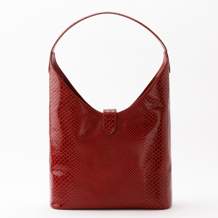 Brahmin Gwynne hobo bag in deep red with a glossy, textured scale-pattern finish, featuring a single rounded shoulder strap, center tab closure, and interior pockets.