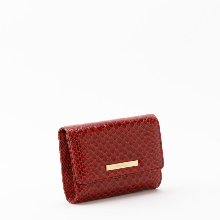 Red Brahmin Kerra wallet in a textured scale pattern, featuring a gold-toned logo bar on the front flap and multiple interior credit card pockets.