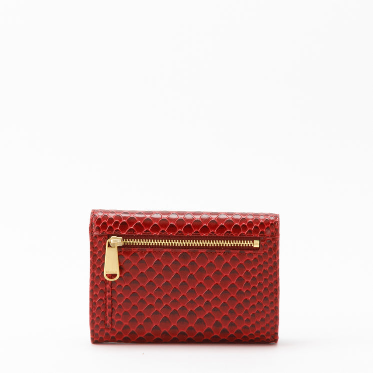 Red BRAHMIN Kerra bi-fold wallet in a textured, scale-like pattern with gold-toned hardware, featuring an exterior zipper pocket and multiple credit card slots on the back.