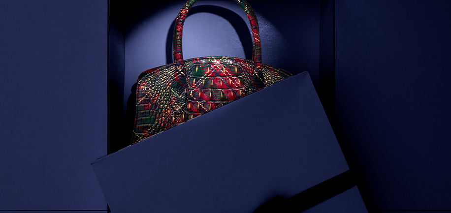 Holly Melbourne Rosetta Satchel inside a dark blue box against a matching background
