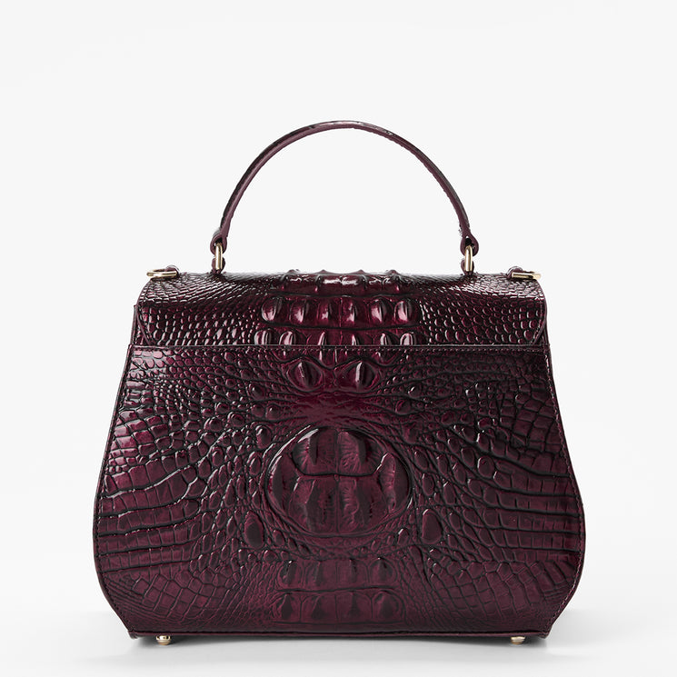 A structured top-handle handbag in glossy embossed crocodile leather, featuring a deep burgundy color and gold-tone hardware, set against a plain white background.