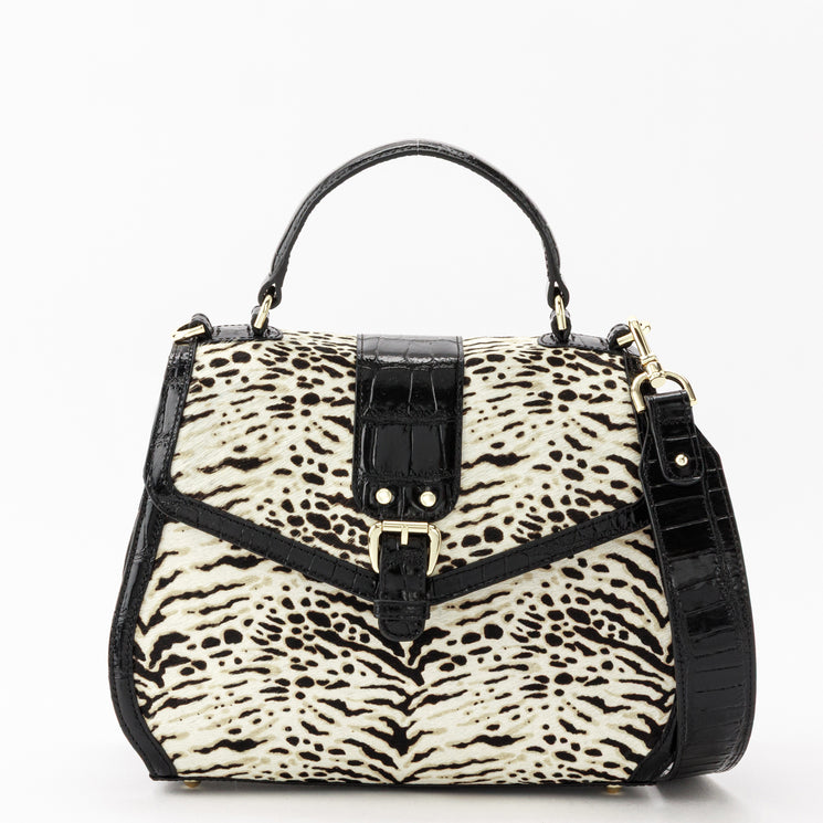 Brahmin Annalise satchel in a black-and-white textured animal print featuring a black flap with turn-lock closure, gold-tone hardware, and an adjustable shoulder strap.