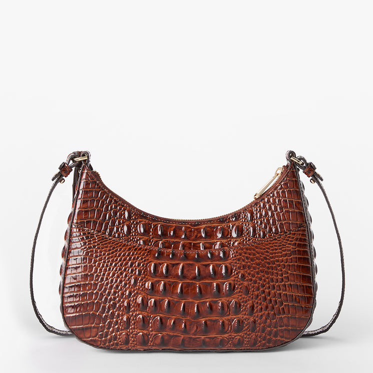 A brown crocodile-embossed leather shoulder bag with a crescent shape and a thin dark strap, shown against a plain white background. Back view.