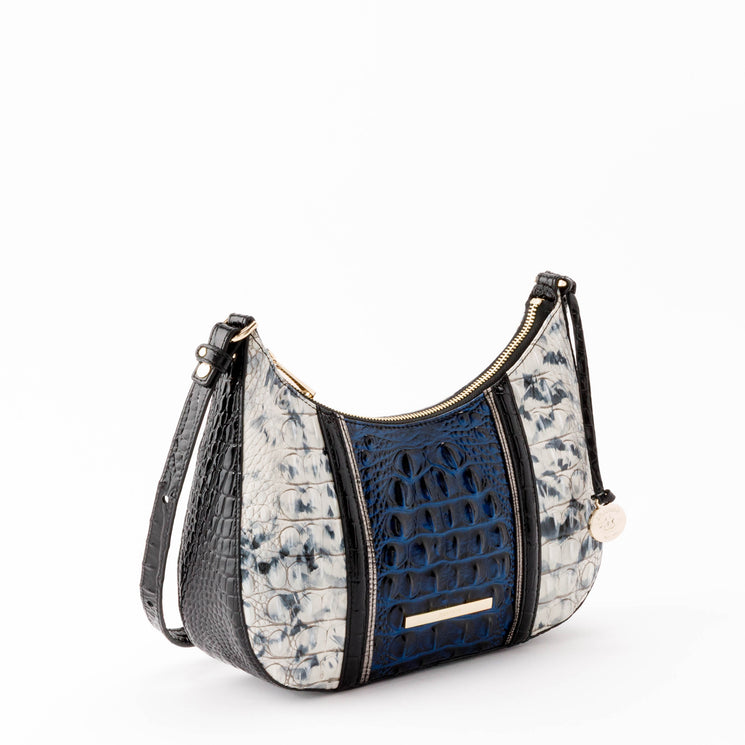 Brahmin Small Stephie crescent-shaped hobo bag in a blue, black, and white textured animal print featuring gold-tone hardware, a top zip closure, and an adjustable shoulder strap.