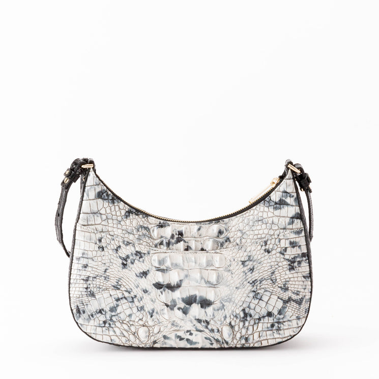 BRAHMIN Small Stephie crescent hobo bag in a black and white embossed animal pattern, featuring a top zipper closure, gold-tone hardware, and an adjustable shoulder strap.