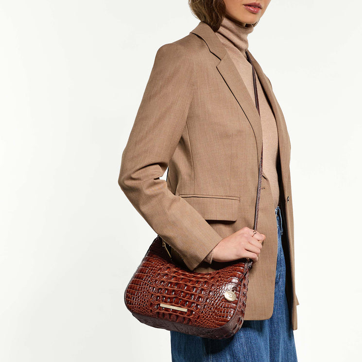 Person wearing a beige blazer wearing Small Stephie crossbody on a white background