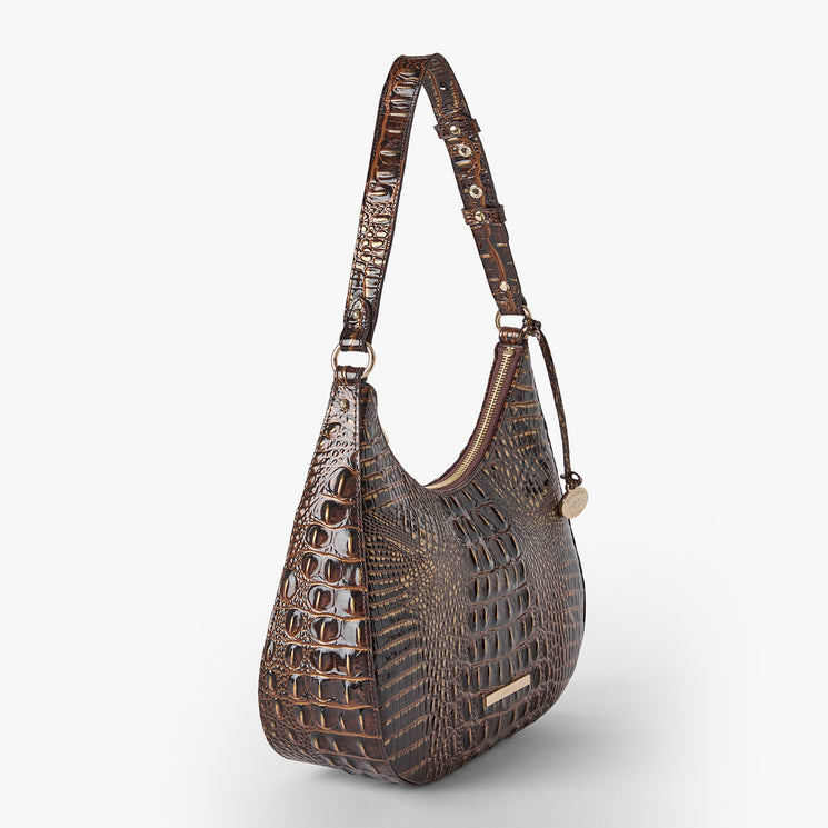 A chocolate crocodile-embossed shoulder bag with a single strap and gold-tone hardware, shown on a light gray background. Side view.