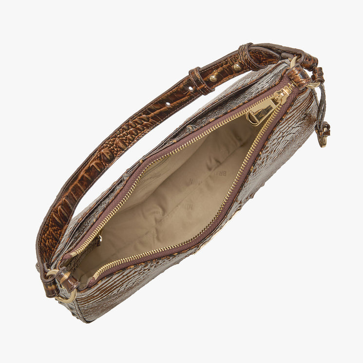 A chocolate crocodile-embossed leather shoulder bag shown open, displaying its tan interior lining and gold-tone zipper hardware, set against a plain light gray background. Open top view.