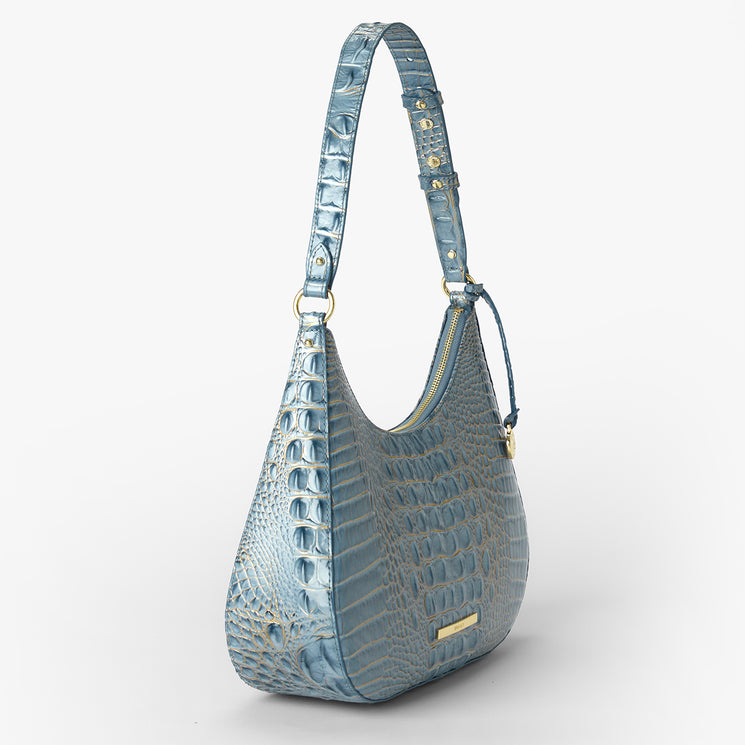 A light blue crocodile-embossed shoulder bag with gold-tone hardware and a matching adjustable shoulder strap, shown on a clean white background.