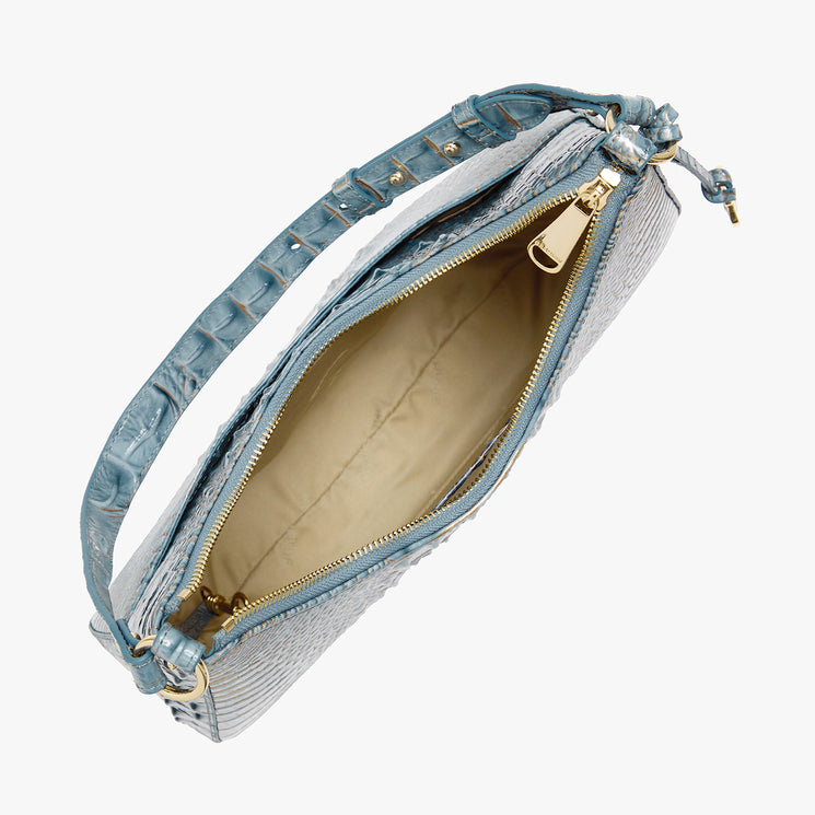 A light blue crocodile-embossed leather shoulder bag with gold-tone hardware, shown open to reveal a beige interior lining, set against a plain white background.