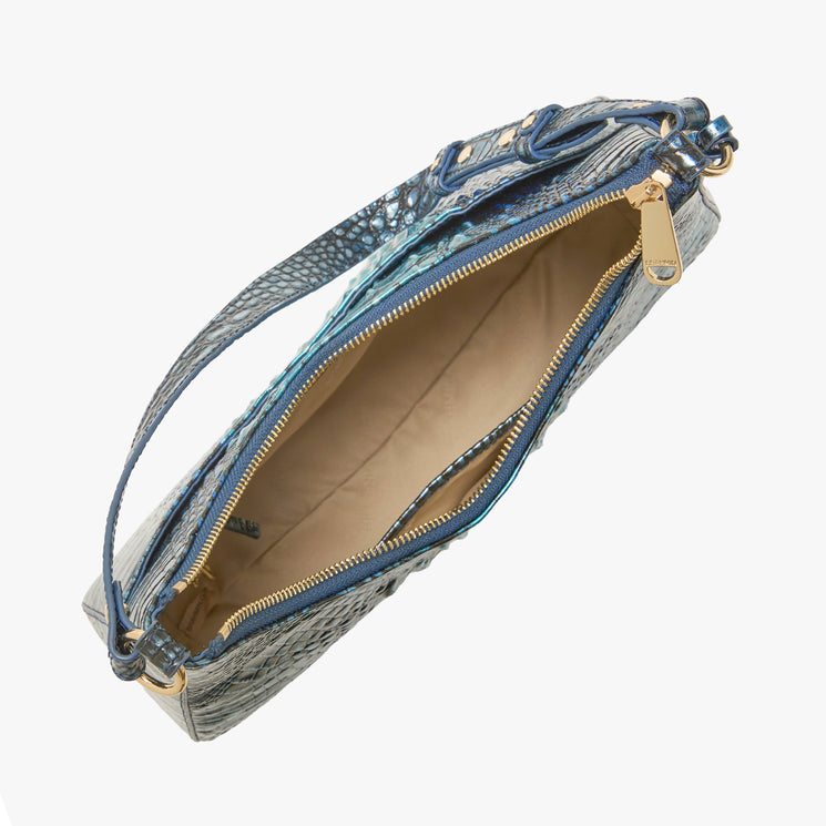 BRAHMIN Stephie crescent shoulder bag in Eternal Blue Ombre with gold zipper, beige interior, and textured patterned exterior, shown open from the top on a white background. Single strap for shoulder wear.