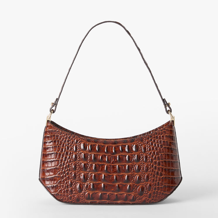 A brown crocodile-embossed leather shoulder bag with a single strap and gold-tone hardware, shown against a plain light gray background. Back view.