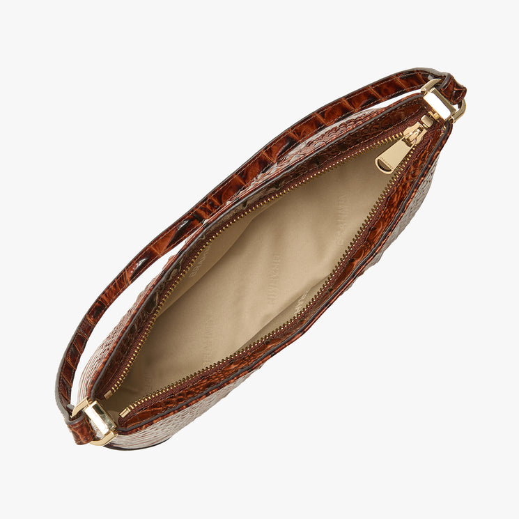 A brown crocodile-embossed clutch bag shown open from an overhead angle, revealing a beige interior lining and gold-tone zipper hardware, set against a plain white background.