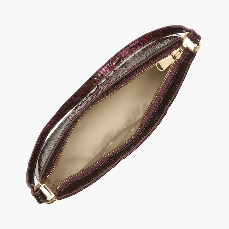 A dark burgundy crocodile-embossed leather clutch bag shown open, revealing a beige satin interior and gold-tone zipper hardware, set against a plain white background.