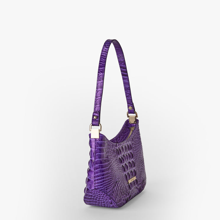 Brahmin purple handbag with embossed textured pattern, structured silhouette, single top strap, gold-tone hardware, small gold Brahmin nameplate on front; displayed on white background.