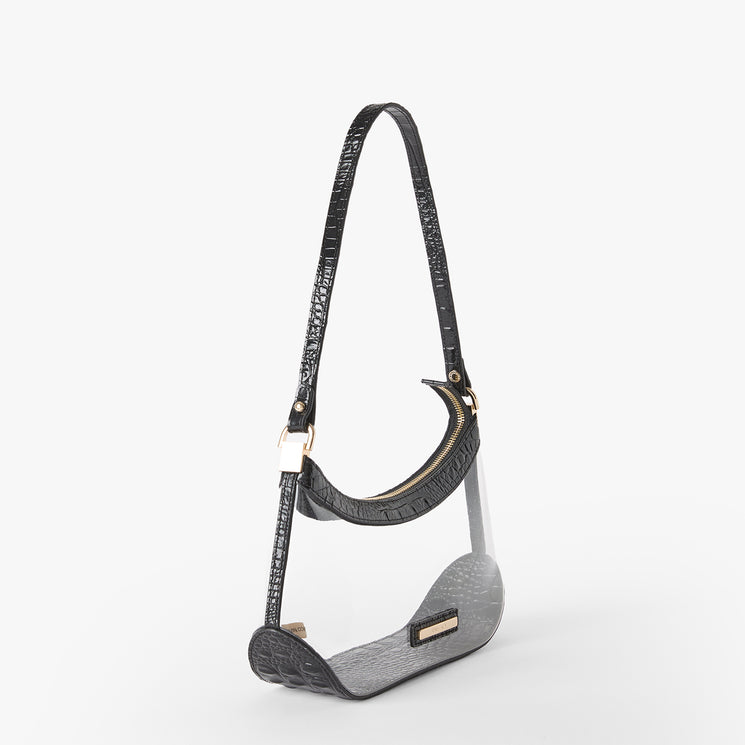 A crescent moon-shaped shoulder bag with a textured black crocodile-embossed strap and trim, paired with a smooth gray body and gold-tone hardware, shown on a light gray background. Side view.