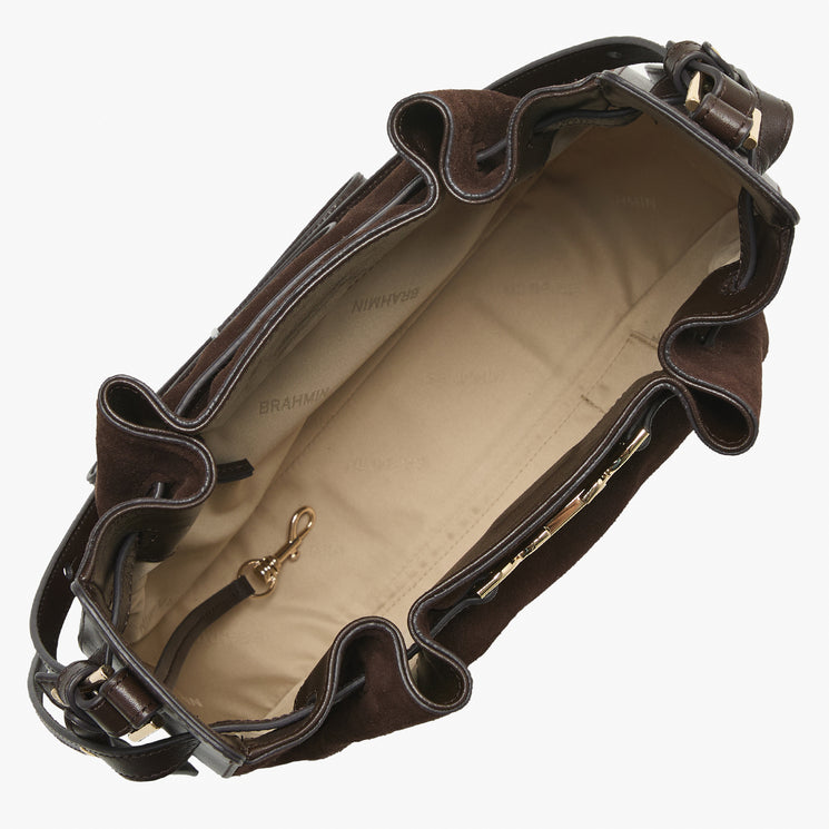 An open dark brown leather shoulder bag with a beige interior lining, showing the interior compartments, gold-tone hardware, and a strap attachment point against a light gray background.