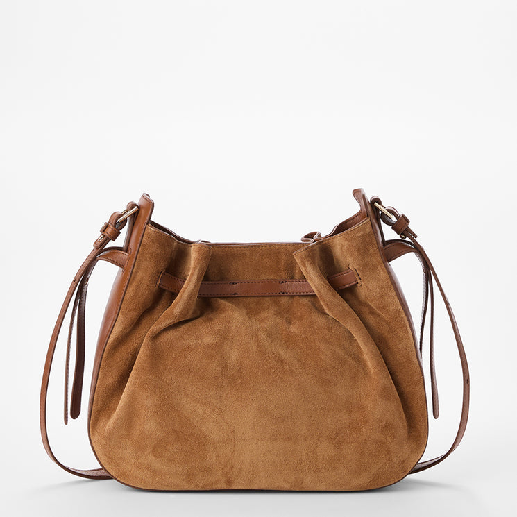 A tan suede slouchy shoulder bag with brown leather trim and straps, shown against a plain white background.