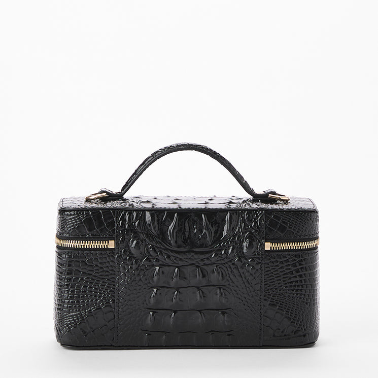 Black crocodile-embossed leather cosmetic case with a top handle and gold-tone zipper details, shown on a plain white background. Back view.