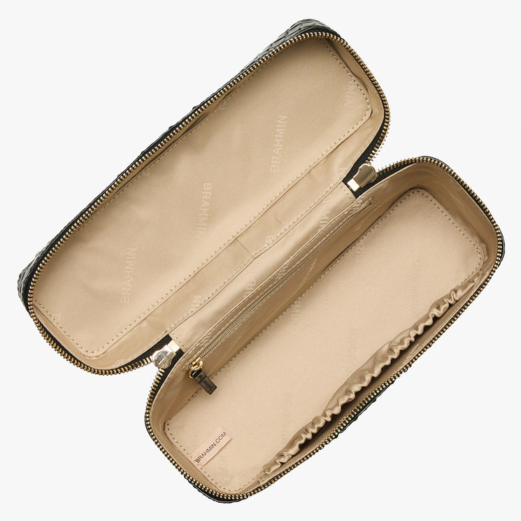 An open rectangular zippered pouch or pencil case with a beige interior and a dark patterned exterior, shown on a plain light gray background.