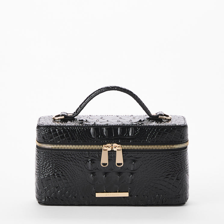 A black crocodile-embossed vanity case or makeup bag with a top handle, gold zipper, and gold hardware, shown against a plain white background. Front view.