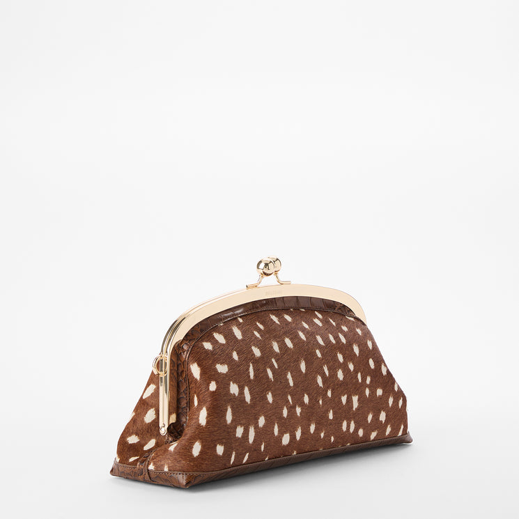 Brahmin brown spotted clutch purse with gold-tone metal frame and clasp, white textured dot pattern, sleek rectangular silhouette, displayed on a plain white background. No strap or interior visible.