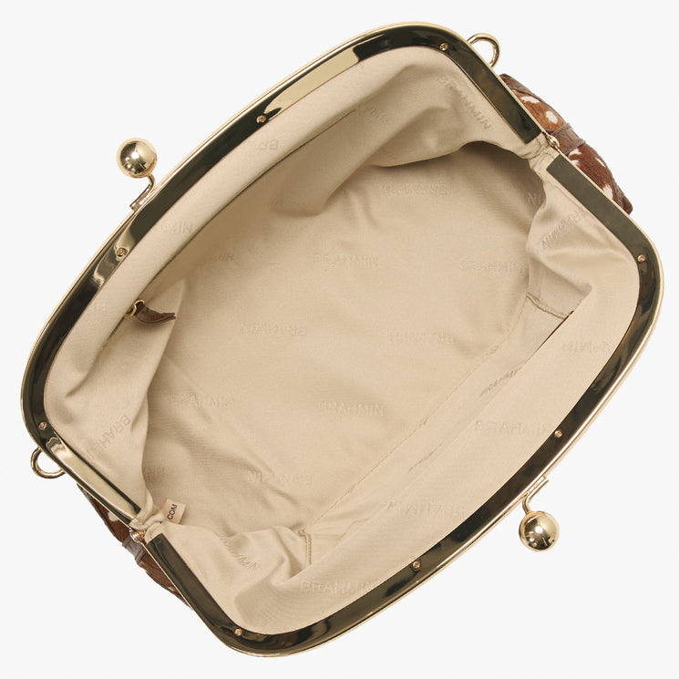Brahmin brown patterned handbag with gold kiss-lock frame, top-handle silhouette, beige fabric-lined interior, and subtle Brahmin logo embossed inside; displayed open and empty to show interior details.