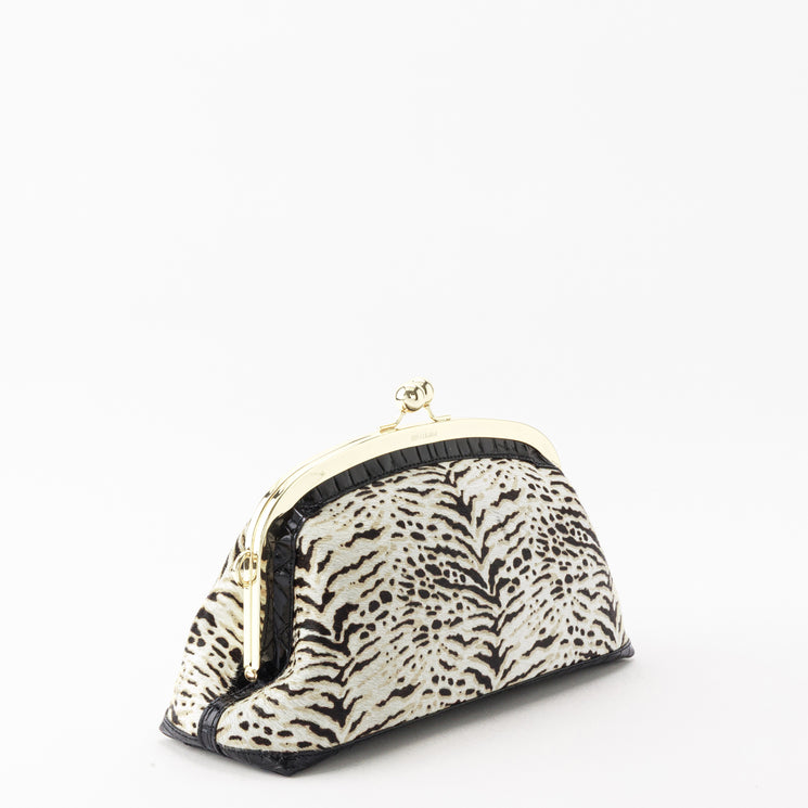 Brahmin Christine small semicircular clutch in black and white, featuring a textured body, black trim, and a gold-tone kiss-lock frame closure.