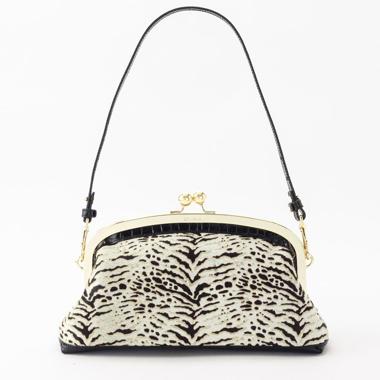 Brahmin Christine frame handbag with a kiss-lock clasp, gold-tone hardware, a black top handle, and a tan and black textured animal-print design.