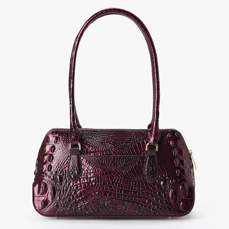 A glossy, deep burgundy handbag with an embossed crocodile pattern, featuring dual top handles and a small gold zipper pull on the right side, set against a plain white background. Back view.