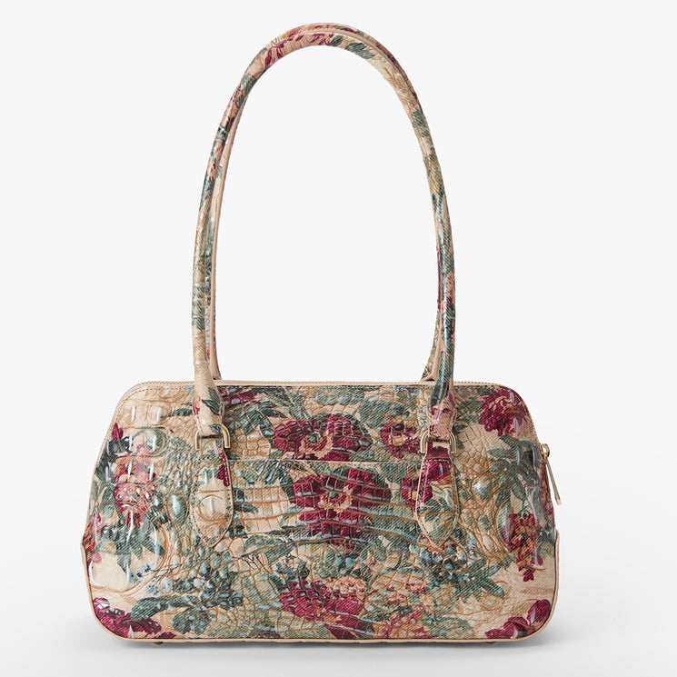 A structured handbag with a textured crocodile-embossed pattern and a vintage floral print in muted red, green, and beige tones, featuring dual top handles and a zippered closure.