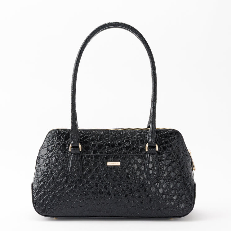 BRAHMIN Jennifer satchel in black embossed leather with dual top handles, structured silhouette, gold-tone nameplate hardware, and all-over textured pattern, shown on a white background.