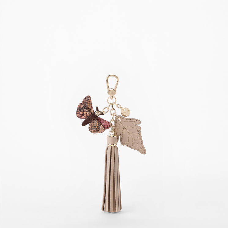 Keychain with butterfly and tassel charm on a white background. Back view.