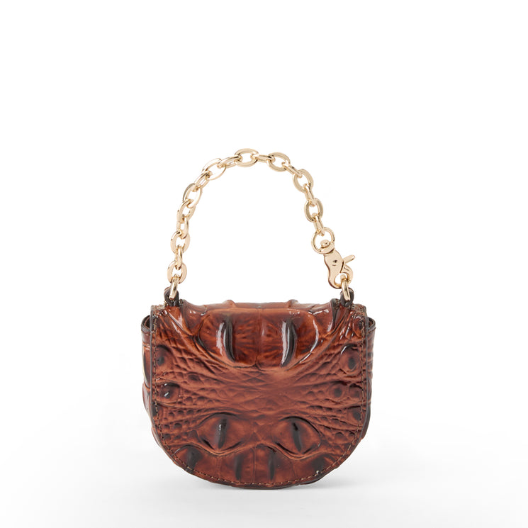 The back of a small brown crocodile-embossed leather handbag with a gold-tone chain handle and a round gold-tone front clasp, photographed on a clean white background.