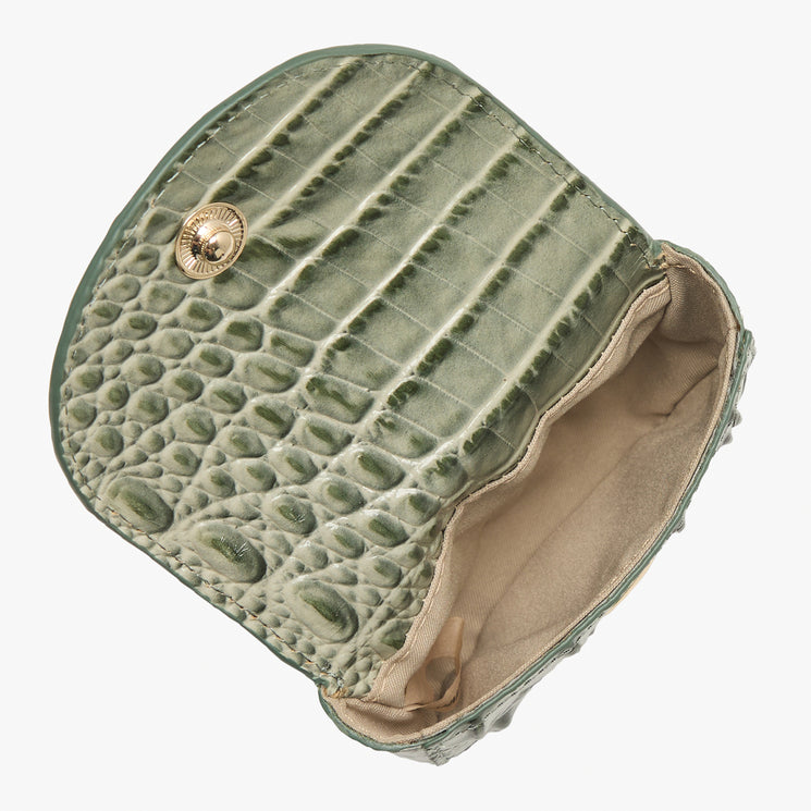 An olive green crocodile-embossed leather coin purse, shown open to reveal a beige interior lining and a gold-tone snap button closure, set against a plain white background.