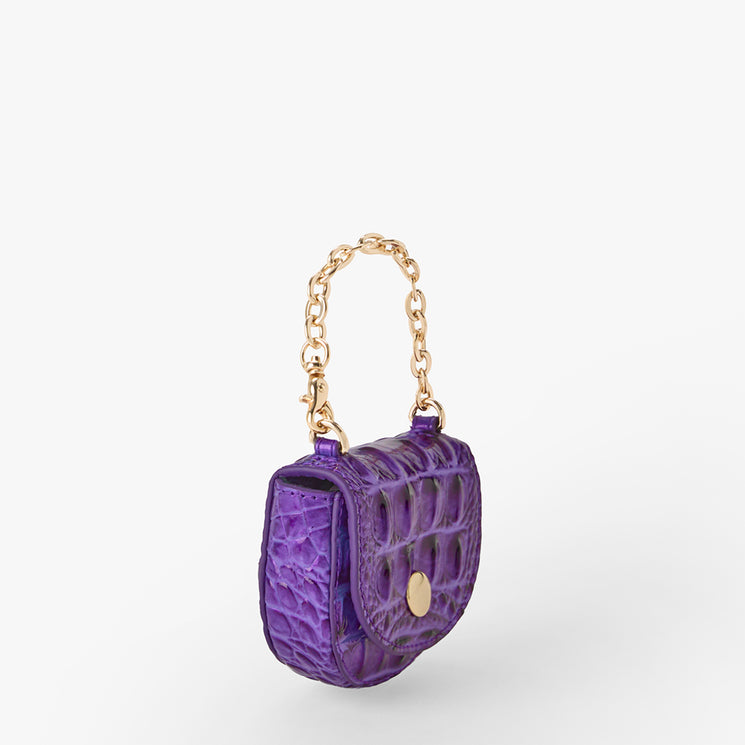 Brahmin purple mini handbag with embossed textured finish, gold chain handle, and button clasp. Compact silhouette shown on a white background, highlighting hardware and chic evening style.
